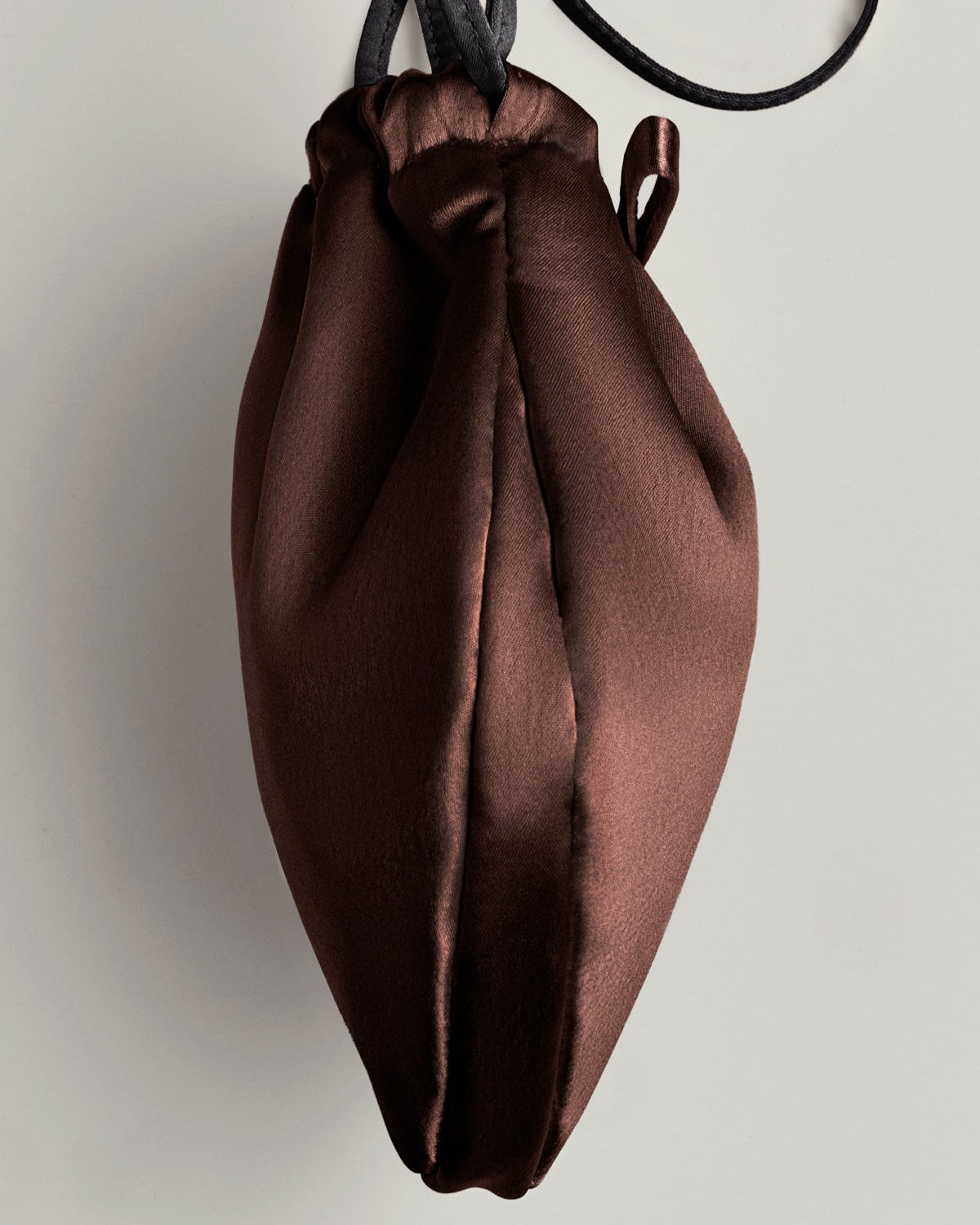 Brown satin drawstring bag on a light gray background